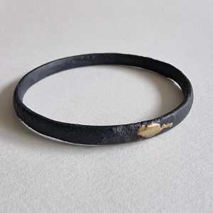 relic-ox-silver-gold-bangle on a table